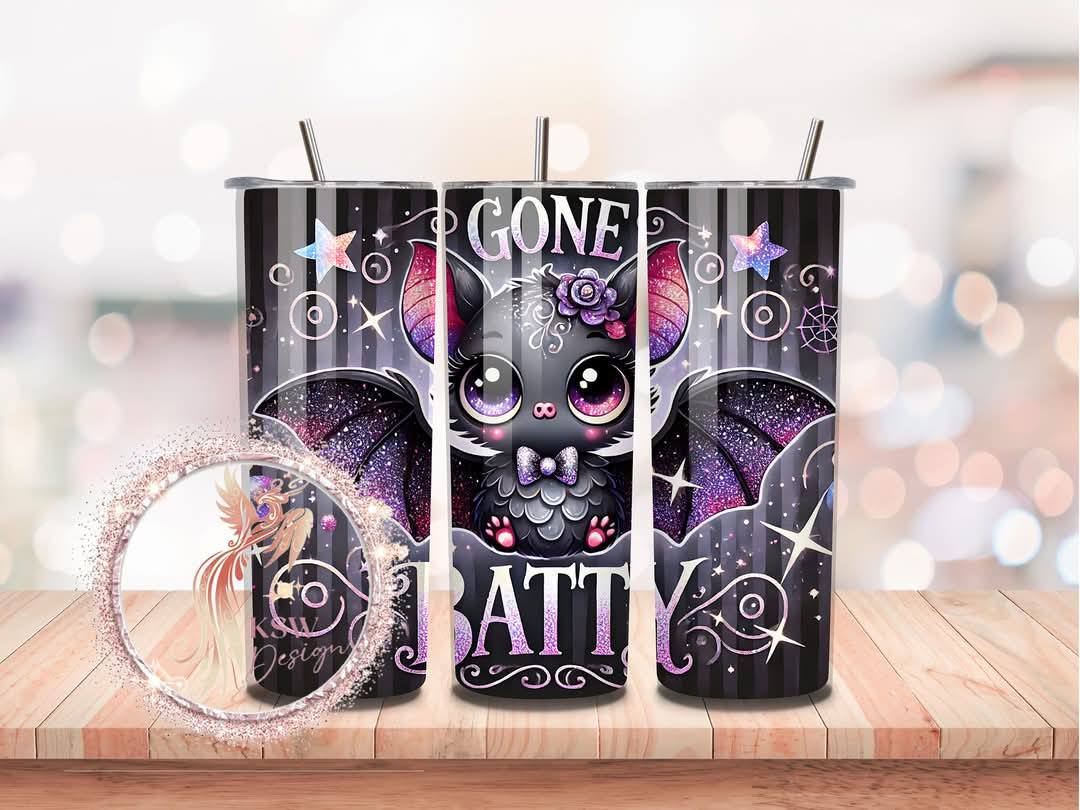 Tumbler with a cat design and text on a wooden surface with a blurred background