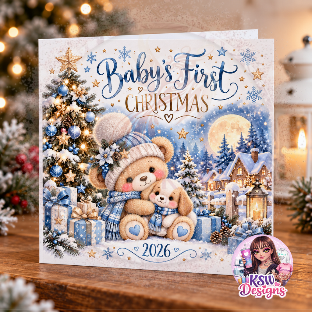 Blue Baby's First Christmas 2026 greeting card featuring a teddy bear cuddling a puppy, blue Christmas presents, a decorated tree and snowy winter cottages.