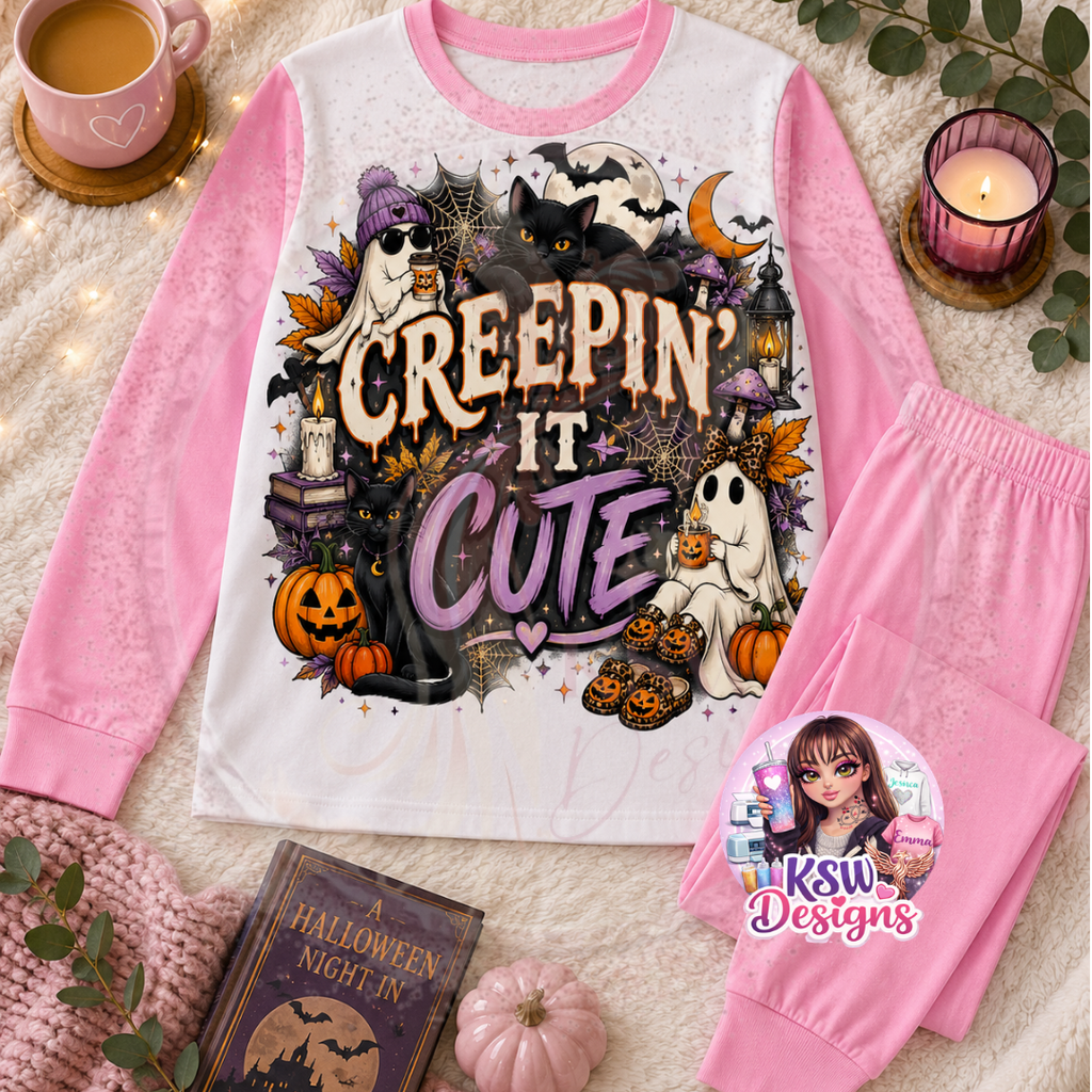 Creepin’ It Cute adult Halloween pyjama set featuring cute ghosts, black cats, pumpkins, bats and cobwebs shown on pink block pyjamas