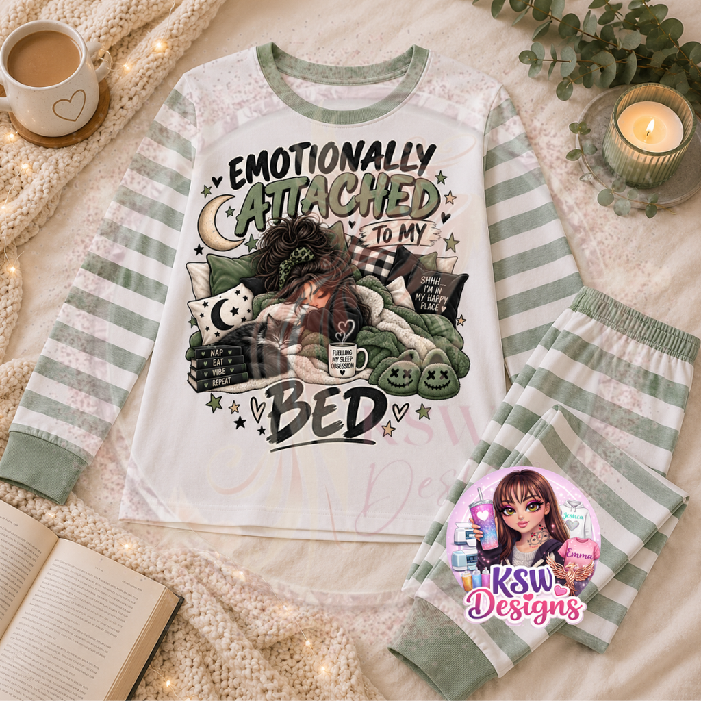 Emotionally Attached To My Bed adult pyjama set with cosy bed, books and cat design shown on sage green striped pyjamas