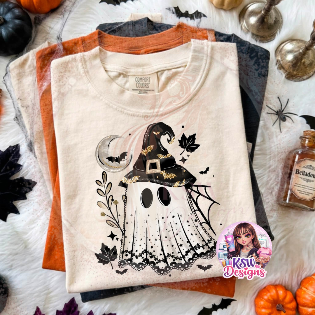 Ghost Witch Halloween T-shirt featuring a cute ghost wearing a black witch hat surrounded by crescent moon, bats, spider web and autumn leaf details.