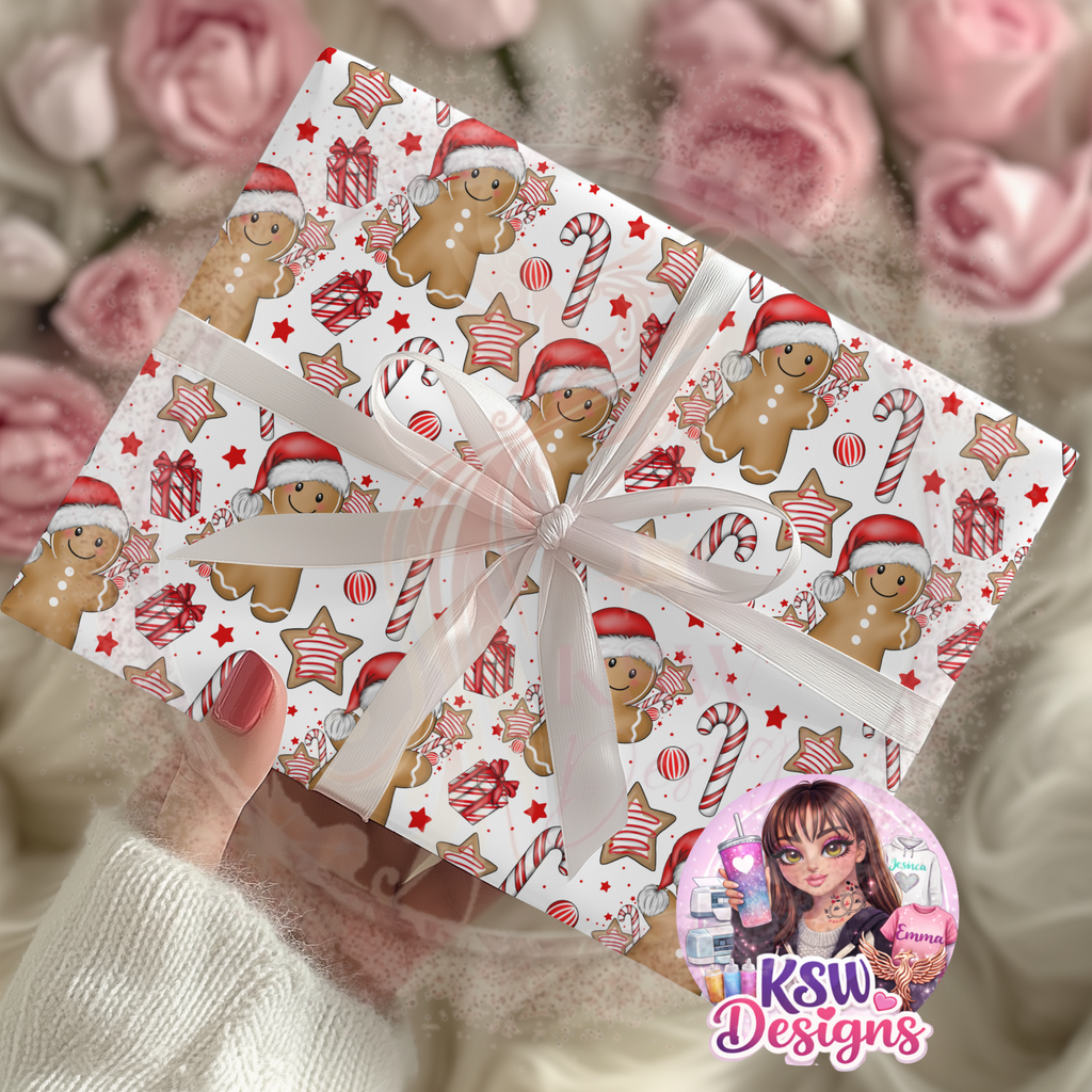 Christmas present wrapped in Gingerbread Wishes A3 wrapping paper featuring smiling gingerbread characters in Santa hats, red candy canes, iced star biscuits and Christmas presents, finished with a white ribbon.