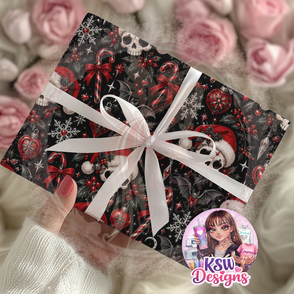 Gift wrapped in black gothic Christmas paper featuring skulls wearing Santa hats, red candy canes, bats, snowflakes and festive holly, finished with a white ribbon.