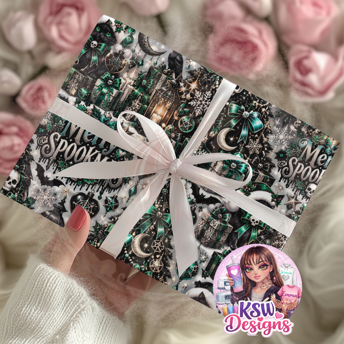 Christmas gift wrapped in gothic green and black paper featuring black cats, emerald bows, crescent moons, snowflakes and skull decorations, tied with a white ribbon.