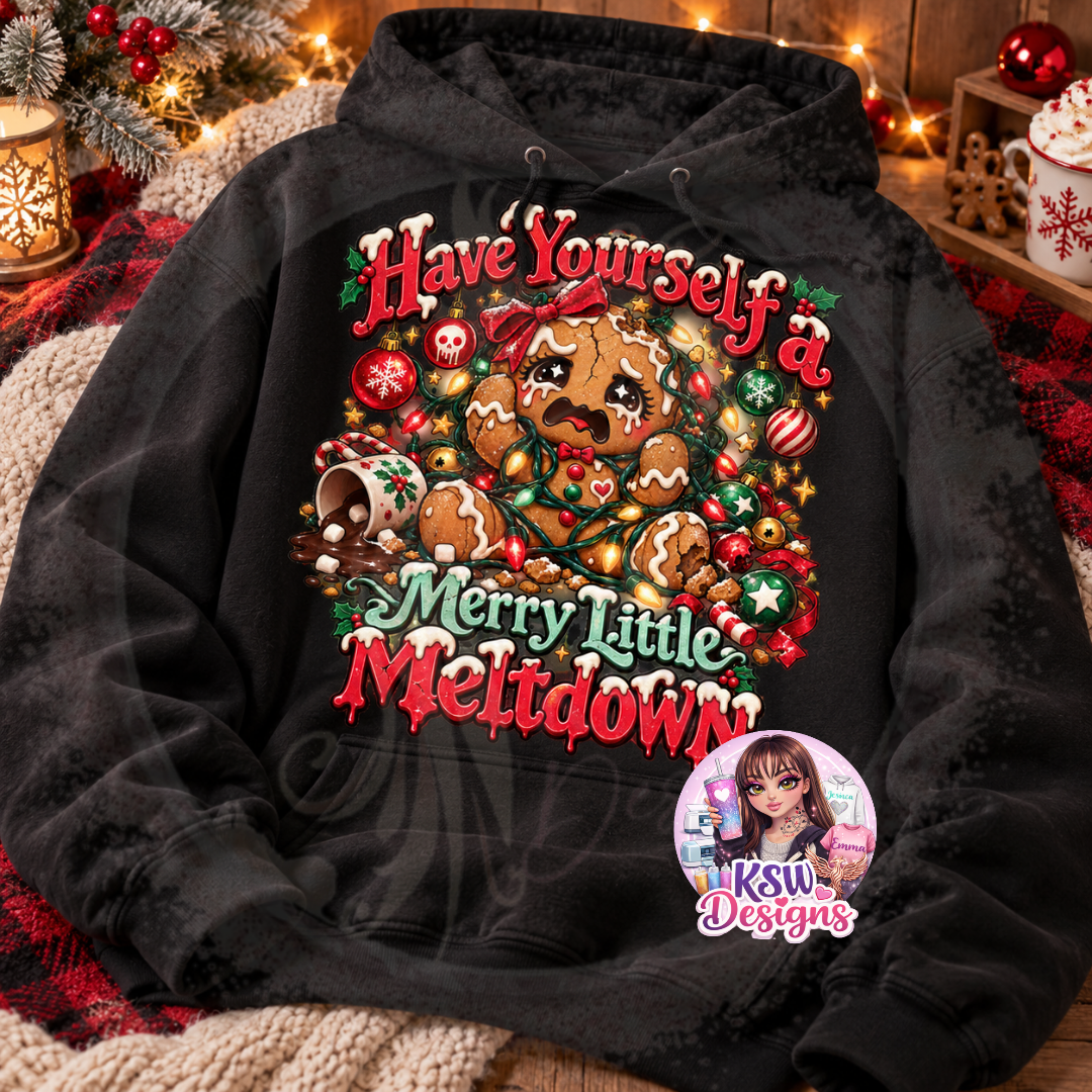 Black hoodie featuring a festive Have Yourself a Merry Little Meltdown design with a crying gingerbread character, Christmas lights, baubles and holiday treats.