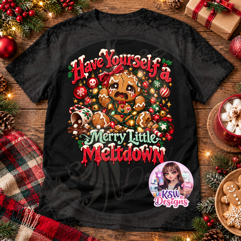 Black Christmas t-shirt featuring a crying gingerbread character tangled in colourful fairy lights, surrounded by festive baubles, candy canes and Have Yourself a Merry Little Meltdown lettering.