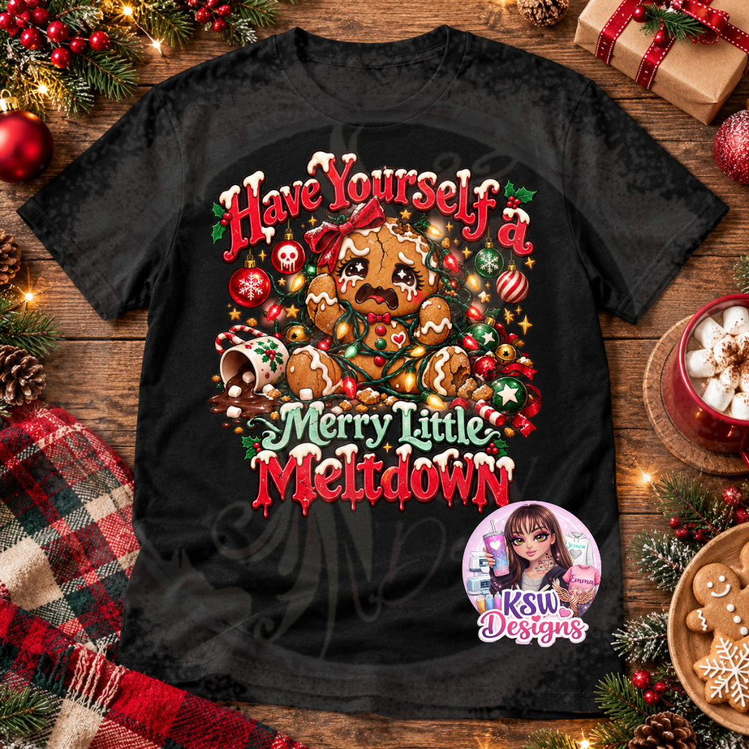Black Christmas t-shirt featuring a crying gingerbread character tangled in colourful fairy lights, surrounded by festive baubles, candy canes and Have Yourself a Merry Little Meltdown lettering.