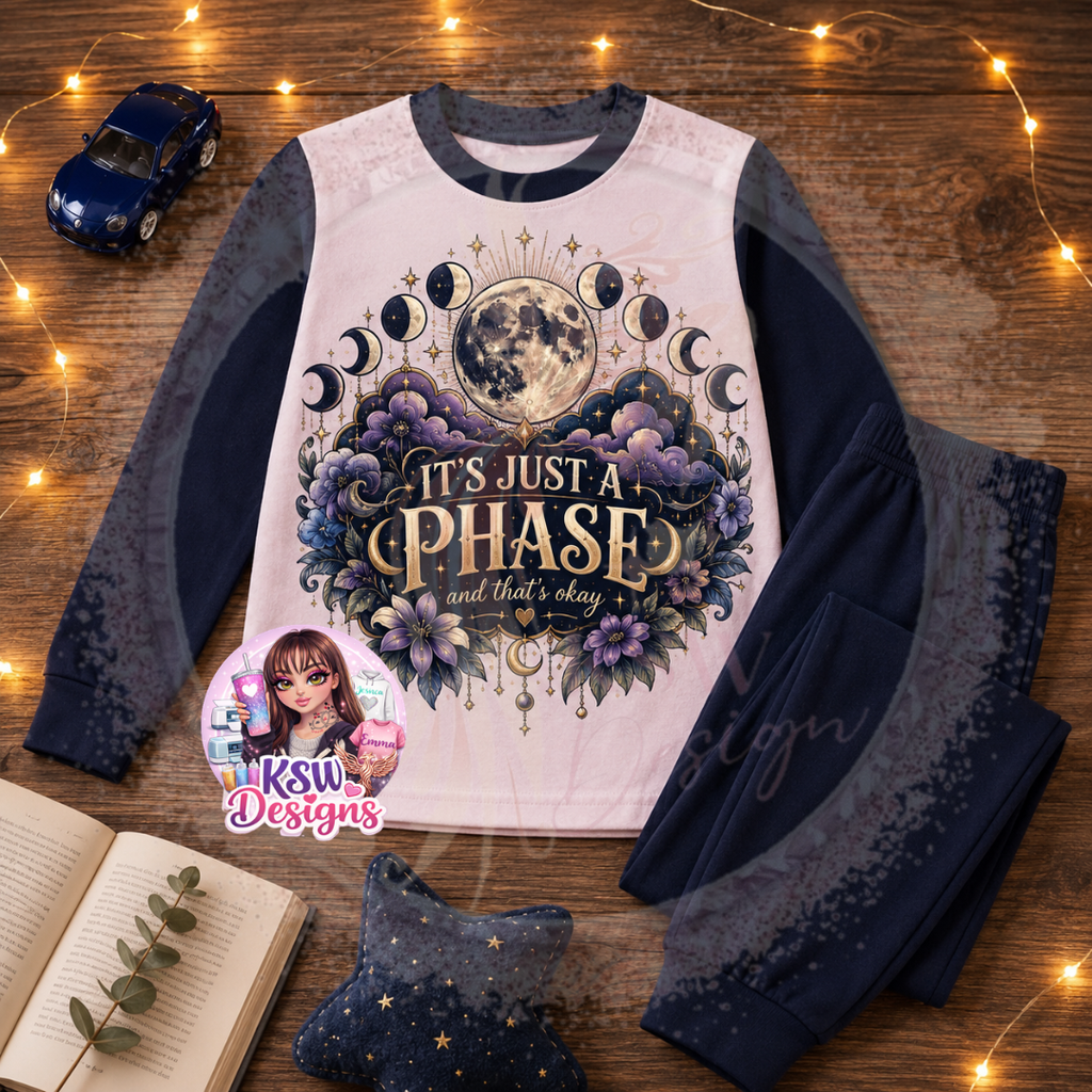 It’s Just a Phase adult celestial pyjama set featuring moon phases, full moon, stars and purple floral details shown on navy block pyjamas