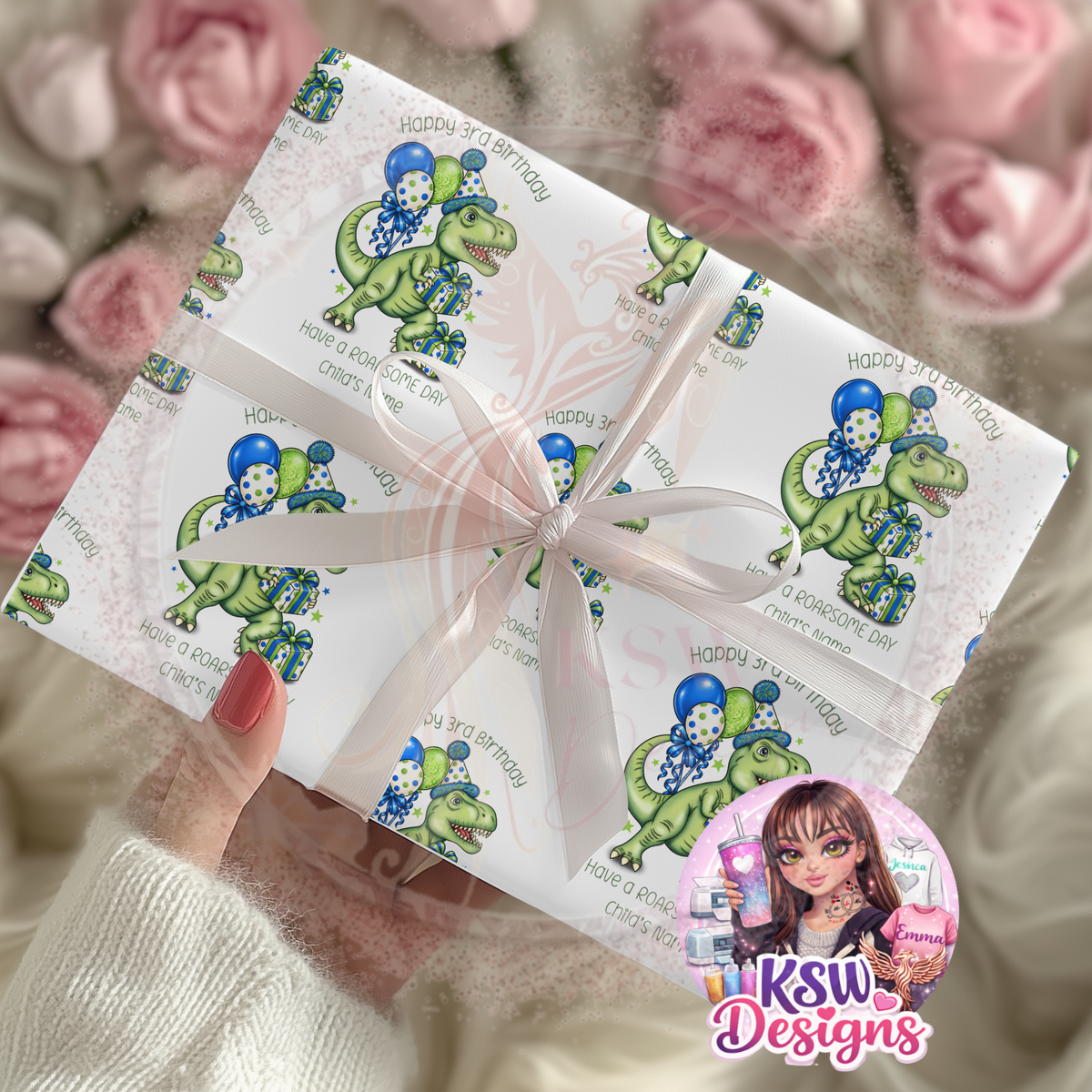 Personalised dinosaur birthday wrapping paper featuring a green T-Rex wearing a party hat with blue and green balloons, presents and Happy 3rd Birthday wording, shown on a wrapped gift with a white ribbon.