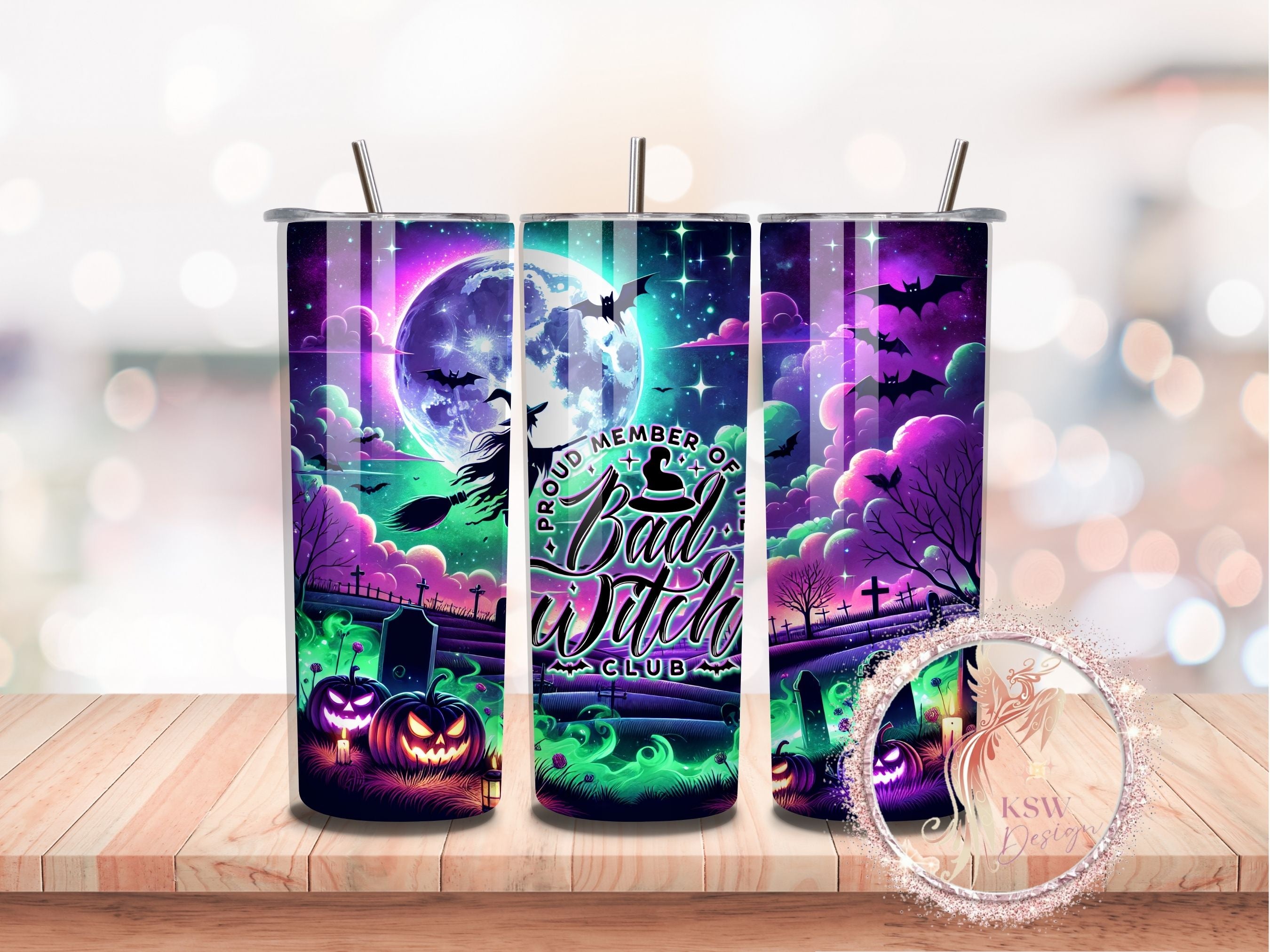 Tumbler with Halloween design featuring a witch, moon, and pumpkins on a wooden surface.