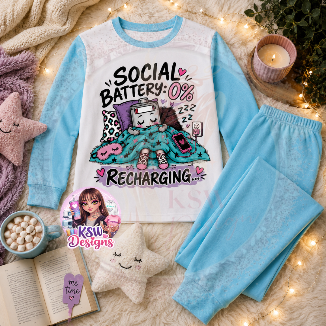 Social Battery 0% Recharging adult pyjama set shown in baby blue with funny sleepy battery design
