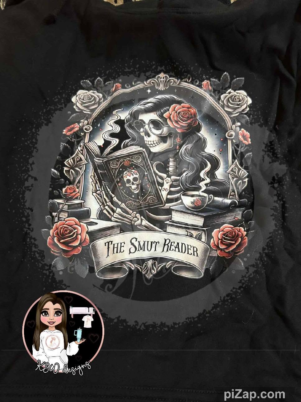 Black The Smut Reader hoodie featuring a gothic skeleton reading a book surrounded by stacked books and red roses in a dark romance bookish design.