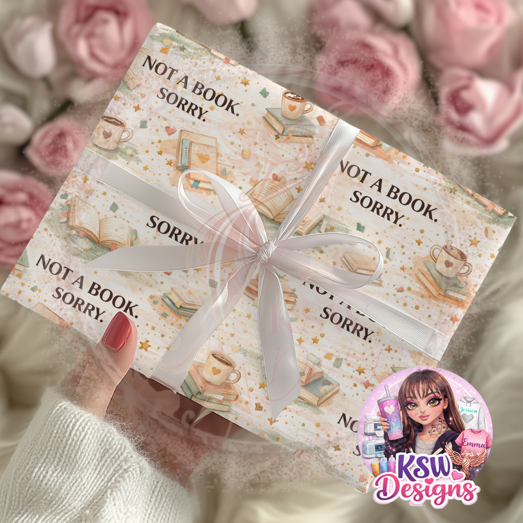 Gift box with 'Not a Book, Sorry' text and a ribbon, surrounded by pink roses, with KSW Designs logo.